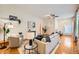 Bright living room featuring hardwood floors, ceiling fan, modern furnishings, and plenty of natural light at 1218 S Josephine St, Denver, CO 80210