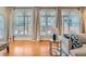 Sunlit living room with hardwood floors, large windows, and stylish neutral decor at 1218 S Josephine St, Denver, CO 80210
