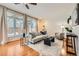 Inviting living room with hardwood floors, a neutral sofa, bright windows and a decorative rug at 1218 S Josephine St, Denver, CO 80210