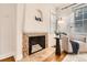 Cozy living room features a charming fireplace, hardwood floors, and an inviting armchair at 1218 S Josephine St, Denver, CO 80210