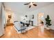Open-concept living room featuring hardwood floors, white brick accent walls and plenty of natural light at 1218 S Josephine St, Denver, CO 80210