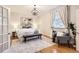 Bright main bedroom boasts a decorative chandelier and ample natural light at 1218 S Josephine St, Denver, CO 80210