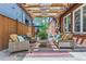 Inviting outdoor patio with comfortable seating beneath a pergola draped with lights at 1218 S Josephine St, Denver, CO 80210