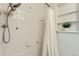 Shower featuring clean, white tiling and a shower curtain for a refreshing and minimalist design at 1218 S Josephine St, Denver, CO 80210
