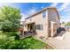 Backyard showing covered patio, lush lawn, and exterior of this inviting two-story house at 13180 Jasmine St, Thornton, CO 80602