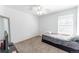 This carpeted bedroom features a ceiling fan, a large window, and neutral colored walls at 13180 Jasmine St, Thornton, CO 80602