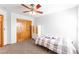 Bedroom with carpeted floors, ceiling fan, closet, bed, and natural light at 13180 Jasmine St, Thornton, CO 80602
