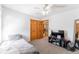 Bedroom with a ceiling fan, double doors, carpeted floors, and a television with a stand at 13180 Jasmine St, Thornton, CO 80602