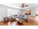 Spacious living room with hardwood floors, a comfortable gray sectional couch, and open access to the kitchen at 13180 Jasmine St, Thornton, CO 80602