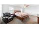 A spacious primary bedroom offers a ceiling fan, a large window, and plush carpet at 13180 Jasmine St, Thornton, CO 80602