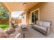 Covered outdoor patio featuring neutral wicker furniture and views to the backyard at 13180 Jasmine St, Thornton, CO 80602