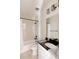 Bathroom with tile shower over tub, granite sink and modern fixtures at 6506 Barnstead Dr, Castle Pines, CO 80108
