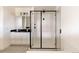 Modern bathroom featuring a glass enclosed shower and double sinks at 6506 Barnstead Dr, Castle Pines, CO 80108