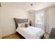 Cozy bedroom with plush headboard, white linens, and natural light at 6506 Barnstead Dr, Castle Pines, CO 80108