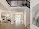Open foyer with hardwood floors, high ceilings, staircase, and access to living room at 6506 Barnstead Dr, Castle Pines, CO 80108