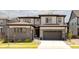 Beautiful two-story home showcasing modern architecture, a two-car garage, and landscaped front yard at 6506 Barnstead Dr, Castle Pines, CO 80108