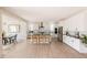 Open-concept kitchen features white cabinets, stainless steel appliances, a center island with seating, and dining area at 6506 Barnstead Dr, Castle Pines, CO 80108