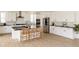 Spacious modern kitchen with white cabinets, stainless steel appliances, a center island, and stylish bar stools at 6506 Barnstead Dr, Castle Pines, CO 80108
