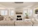 Bright and airy living room with modern lighting, fireplace and comfortable seating at 6506 Barnstead Dr, Castle Pines, CO 80108