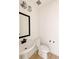 White powder room with pedestal sink, modern faucet, and natural light at 6506 Barnstead Dr, Castle Pines, CO 80108