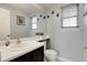 Half bathroom featuring a white sink and toilet, complemented by natural light at 3699 S Killarney St, Aurora, CO 80013