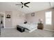 This bedroom features a ceiling fan, comfortable bed, carpet, and natural light at 3699 S Killarney St, Aurora, CO 80013
