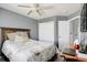 This bedroom offers a ceiling fan, closet and a comfortable bed with a floral patterned comforter at 3699 S Killarney St, Aurora, CO 80013
