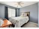Cozy bedroom featuring a ceiling fan and a comfortable bed with a floral patterned comforter at 3699 S Killarney St, Aurora, CO 80013