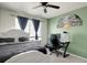 Bedroom with a white bed frame, dark bedding, and a dedicated desk area for work or study at 3699 S Killarney St, Aurora, CO 80013
