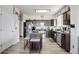 Well-lit kitchen featuring stainless steel appliances and center island with bar stool seating at 3699 S Killarney St, Aurora, CO 80013