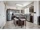 Kitchen with stainless steel appliances, an island with seating, and wood-look floors at 3699 S Killarney St, Aurora, CO 80013