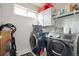 Well-equipped laundry room with modern washer and dryer, storage cabinets, and ample counter space at 3699 S Killarney St, Aurora, CO 80013