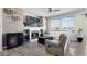 Cozy living room featuring a fireplace, mounted TV, and gray wood-look flooring at 3699 S Killarney St, Aurora, CO 80013