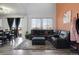 Inviting living room with modern decor, a plush sectional sofa, and ample natural light at 3699 S Killarney St, Aurora, CO 80013