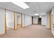 Spacious basement with carpeted floor and view of storage room at 8725 Meadowlark Cir, Highlands Ranch, CO 80126