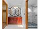 Bathroom features double sinks, ornate mirror, black granite countertops, and tile shower with glass door at 8725 Meadowlark Cir, Highlands Ranch, CO 80126