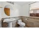 Bathroom features modern fixtures, tile accents, round mirror, and plenty of natural light at 8725 Meadowlark Cir, Highlands Ranch, CO 80126