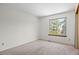 Bright bedroom with large window, plush carpet, and neutral walls at 8725 Meadowlark Cir, Highlands Ranch, CO 80126