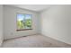 Bright bedroom with large window, plush carpet, and neutral walls at 8725 Meadowlark Cir, Highlands Ranch, CO 80126