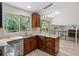 Kitchen features wood cabinets, granite counters, mosaic tile backsplash, stainless dishwasher, and sliding door to deck at 8725 Meadowlark Cir, Highlands Ranch, CO 80126