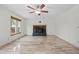 Bright living room featuring tile floors, a ceiling fan, and a cozy fireplace at 8725 Meadowlark Cir, Highlands Ranch, CO 80126