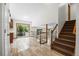Open-concept living area with tile floors, staircase, and sliding glass doors to the outside at 8725 Meadowlark Cir, Highlands Ranch, CO 80126