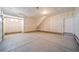 Clean garage with a garage door, pedestrian door, ample space, and good lighting for parking and storage at 22092 E 38Th Pl, Aurora, CO 80019