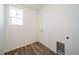 Compact laundry area showcasing connections, a window for natural light, and a well-maintained laminate floor at 22092 E 38Th Pl, Aurora, CO 80019