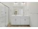 Spacious bathroom featuring a double vanity, large mirror and glass enclosed shower at 770 N Deer Park St, Watkins, CO 80137