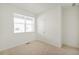 Bright bedroom with neutral carpet, a window, and a door at 770 N Deer Park St, Watkins, CO 80137