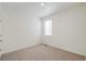 Empty, neutral bedroom with a window and door at 770 N Deer Park St, Watkins, CO 80137