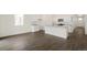 Bright open-concept kitchen features an island, granite countertops, and wood flooring at 770 N Deer Park St, Watkins, CO 80137