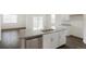 Granite island with stainless dishwasher and modern cabinets in a luxury kitchen at 770 N Deer Park St, Watkins, CO 80137