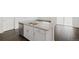 Close up of kitchen island with stainless dishwasher and white cabinets at 770 N Deer Park St, Watkins, CO 80137